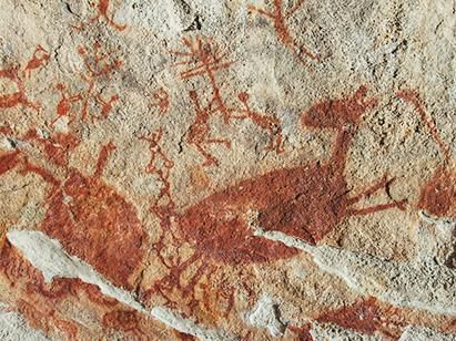 Pedra painting with red deer and humans